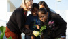 Elementary students examine leaf with teacher