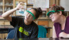 High school student and teacher conduct science experiment